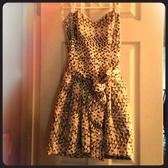 Black, gold and cream strapless dress with tie.
