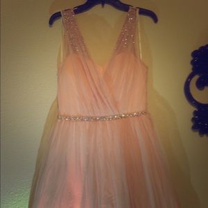 A mid length light pink formal rhinestone dress