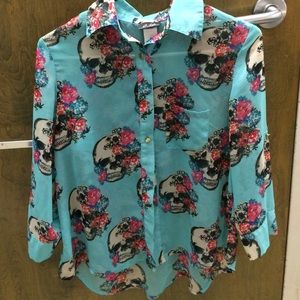 A button down blouse with flowers and skulls