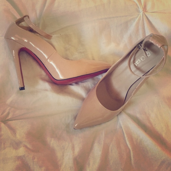 Nude heel ankle strap with red bottoms.