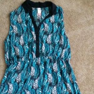 Sheer sleeveless top. Teal and black design