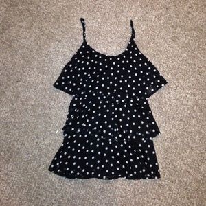 A black and white polka dot ruffle tank top