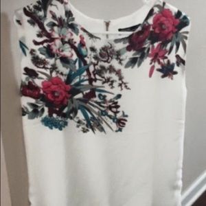 White and floral top w/ zipper back.