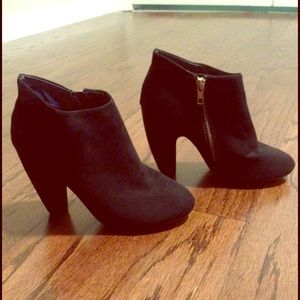 Black booties with gold zippers