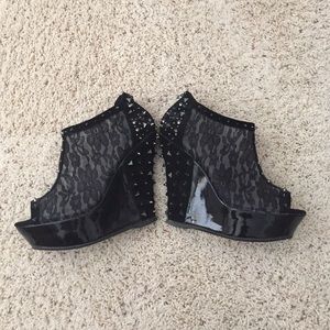 Wedge black lace booties with stud detailing.