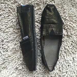 Toms gold and black shoes