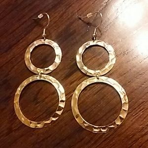 Gold toned double hoop earrings with plastic tab