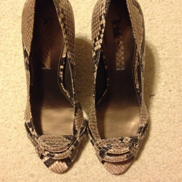 Peeptoe pump with snakeskin pattern.