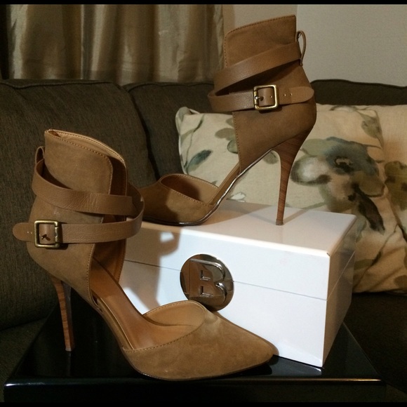 Ankle strap pointed toe brown suede heels.