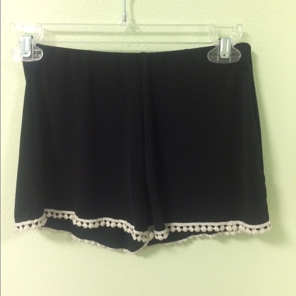 Black shorts with pom poms