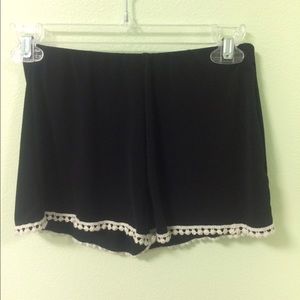 Black shorts with pom poms