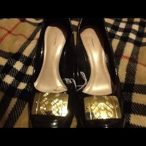 Black patent leather shoes, big gold accent!