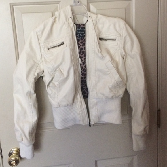 White leather jacket with cheetah print inside.