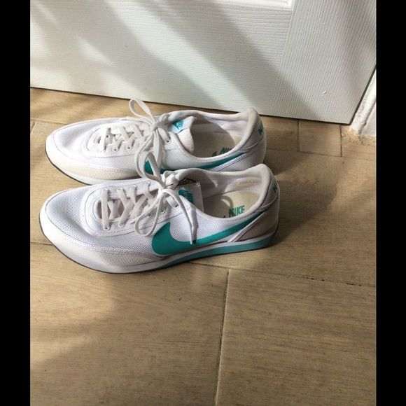White and bluish green Nike trainers