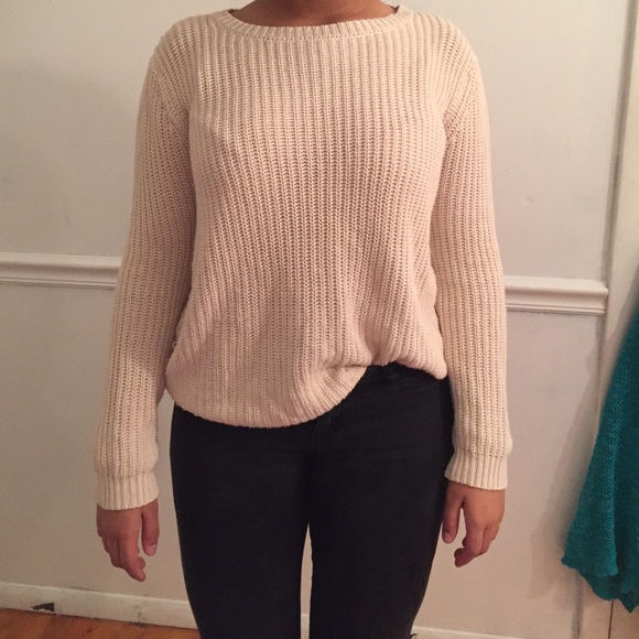 an eggshell colored knitted sweater