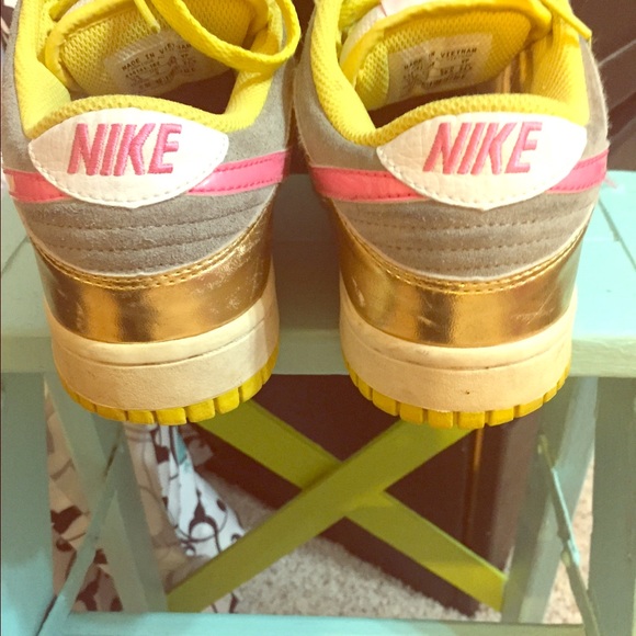 Nike gold and pink 6.0 tennis shoes.