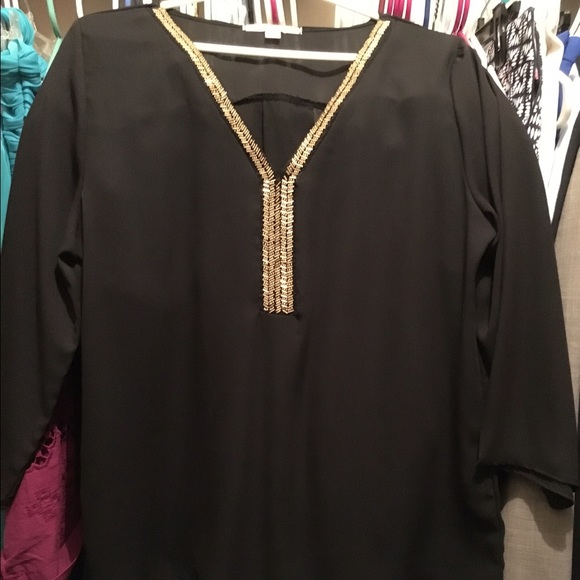 Rayon long sleeve beaded blouse.