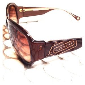 Light brown coach sunglasses with side detail.