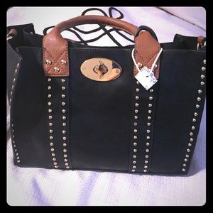 Black purse with brown handles and gold pieces