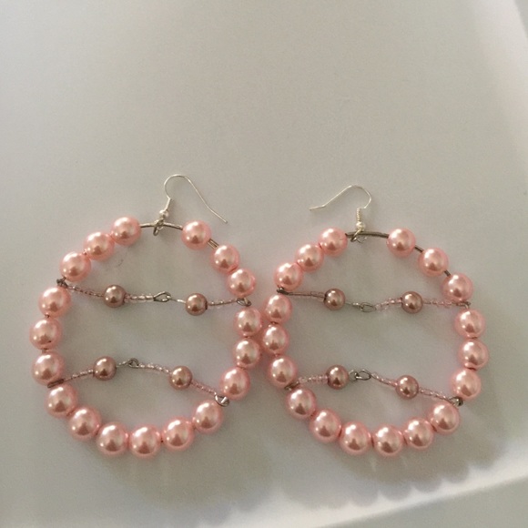 Pink beaded hoop earrings.
