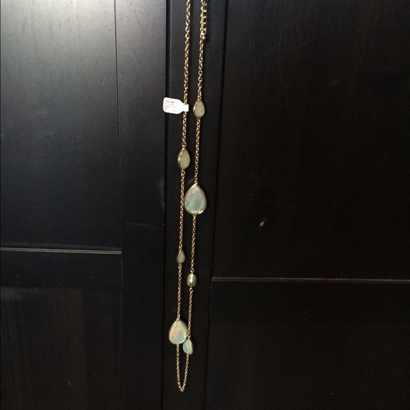 Long gold necklace with green oval large jewels