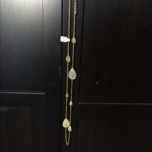 Long gold necklace with green oval large jewels