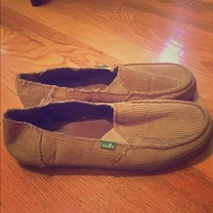 Tan Sanuk shoes.