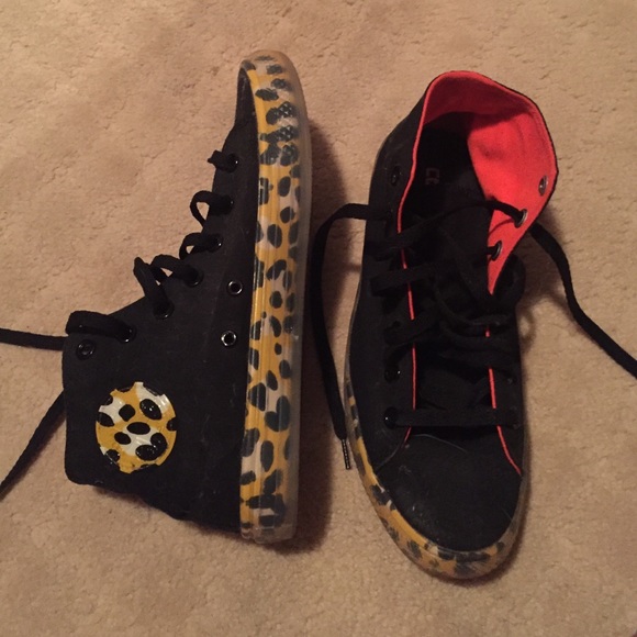 Leopard print and black high top converse