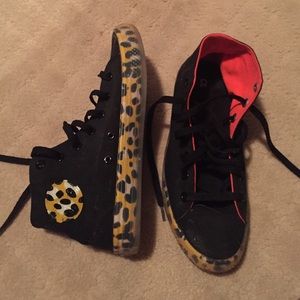 Leopard print and black high top converse