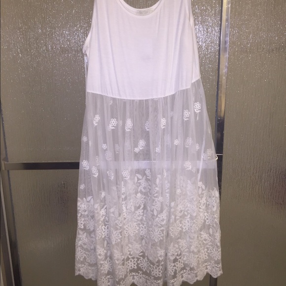 White dress with flower embroidered on the bottom.