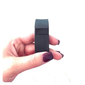 Black Fitbit charge with charger.
