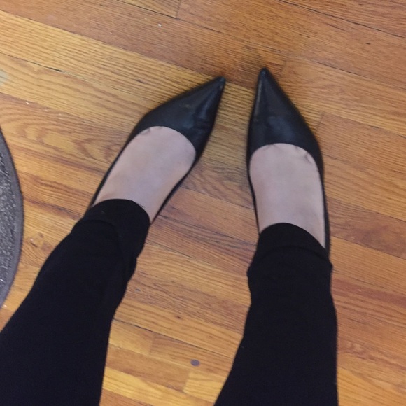 Solid black nine west pointed toe pumps.