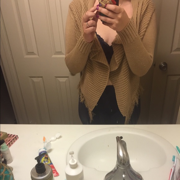 Fringe camel color sweater with a poncho look