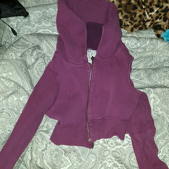 Maroon colored crop top zip up hoodie.