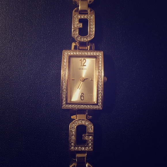 Gold GUESS watch with cubic zirconias.