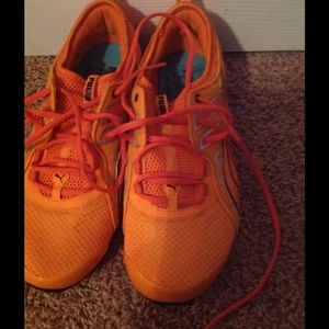 Orange puma tennis shoes
