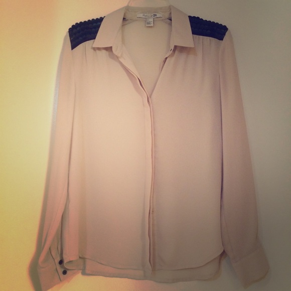 Nude blouse with cute shoulder accent.