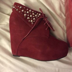 Red suede booties with silver studs.