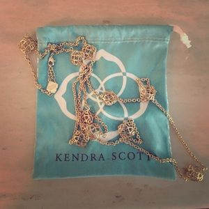 Gold Kendra Scott necklace.