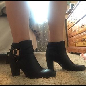 Black heel booties with gold buckles