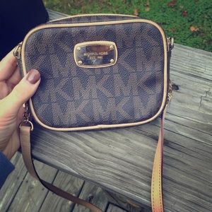 Dark brown MK cross body bag with gold emblem