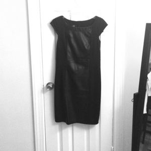 Black sheath dress with leather panel.