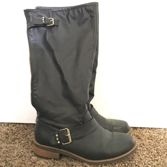 Tall black boots with gold buckles