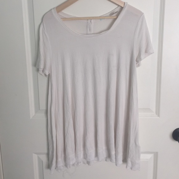 white flowy top with back buttons.
