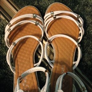 White sandals with gold detailing