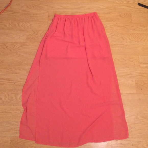 The dress is salmon and is open on the sides .