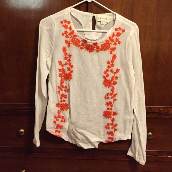 Sabine white blouse with orange floral accent