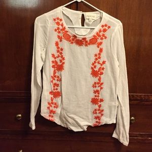 Sabine white blouse with orange floral accent