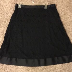 A-line black lace skirt with trim.