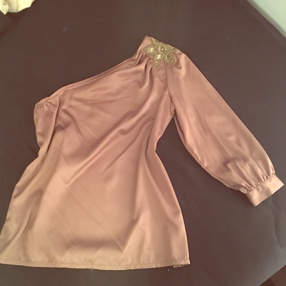 Jennifer Lopez one shoulder silky shirt.